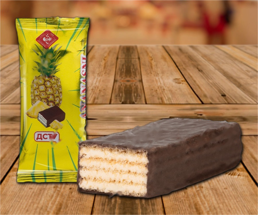 Waffle confection with pineapple-flavored filling in chocolate glaze